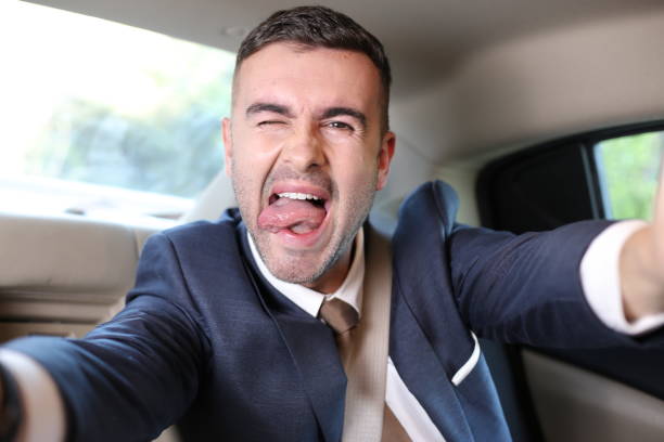 istock Businessman taking a selfie during road trip 1308420333