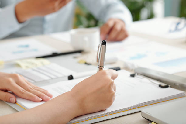 istock Businesswoman signing contract 1308423579