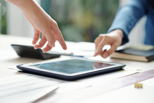 istock entrepreneurs pointing at screen of digital tablet 1308423632