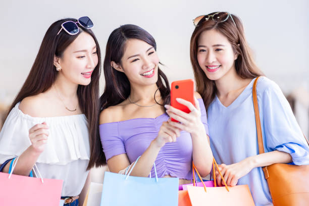 istock three women look at smartphone 1308424508