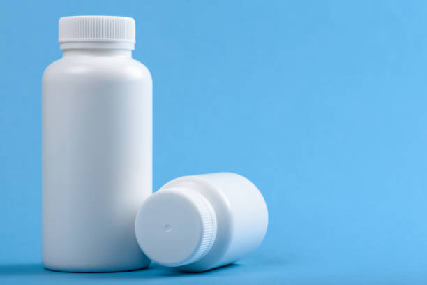 istock two white medical plastic bottles on blue background 1308424601