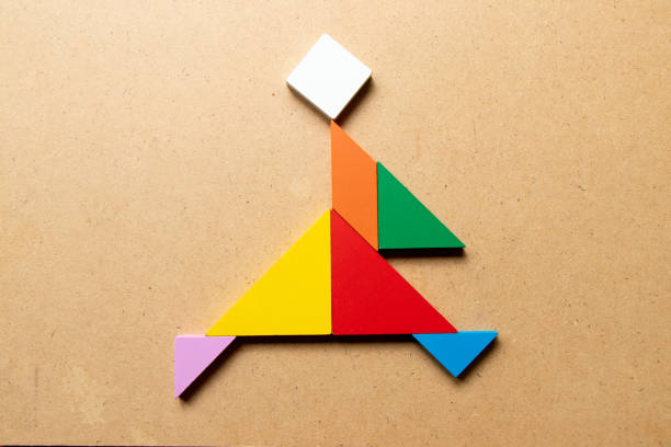 istock Color tangram puzzle in running man shape on wood background 1308425259