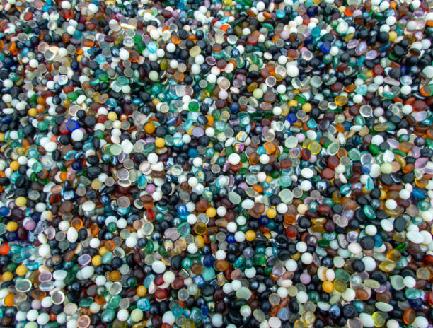 Thousands of marbles in a big group. A macro photograph of thousands of colorful marbles makes a pretty background or texture and is a delight to the collector. Slight bokeh effect. abundance photos stock pictures, royalty-free photos & images