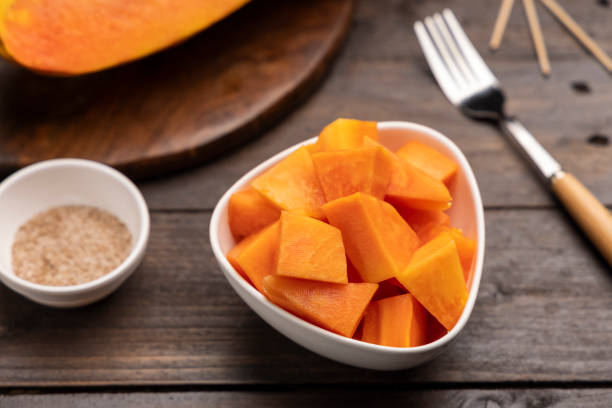 istock Sliced ripe papaya fruit on white plate ready to eat 1308428189