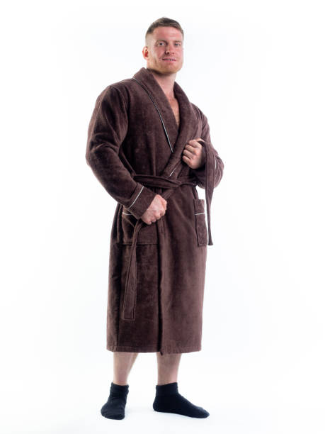 istock strong man in a Bathrobe on an isolated white background with a smile on his face. 1308429335