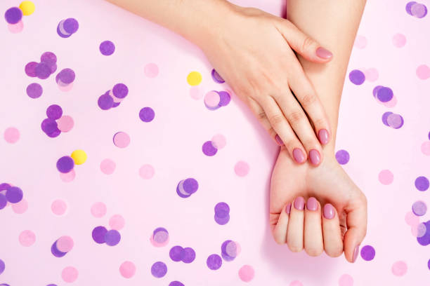 istock Beautiful female hands on a pink background. 1308430949
