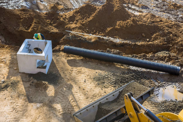 istock Construction of drain system with in ground with trench dug for a new link road under construction 1308431198