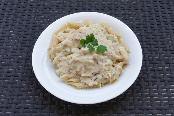 Penne pasta with carbonara sauce and parmesan cheese. Italian food.