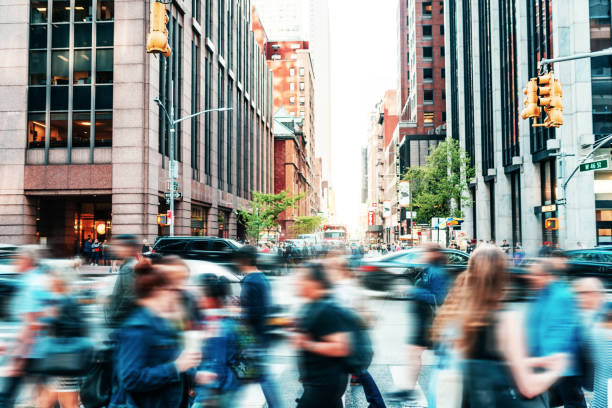 Crowded street with people in New York in springtime Crowded street with people in New York commuter stock pictures, royalty-free photos & images