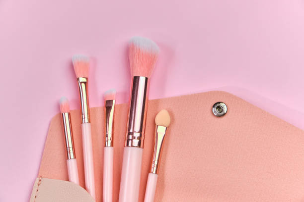 istock Make up brushes spilling out of a beige cosmetics bag 1308432363