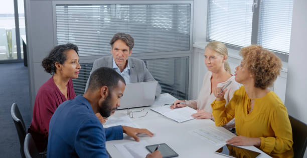 istock Business people talking with each other in office 1308432413