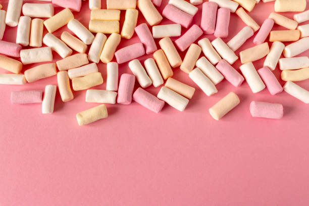 istock Colorful marshmallows on a pink background. Close-up. Selective focus. 1308433977