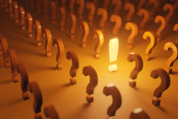istock An orange glowing exclamation point in the middle of question marks. 1308434073