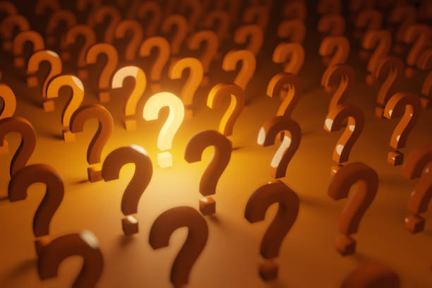 istock Bright question mark illuminating light in the middle of several other question marks. 1308434097