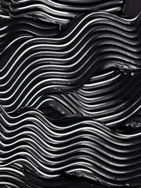 Black paint background with abstract pattern