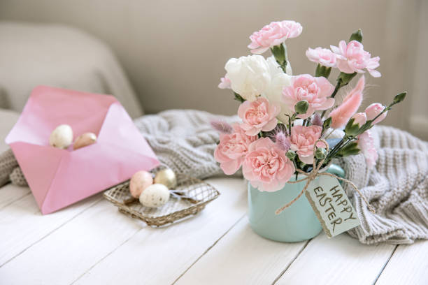 istock Easter composition with fresh flowers in a vase, a knitted element and the inscription Happy Easter on the card. 1308435722