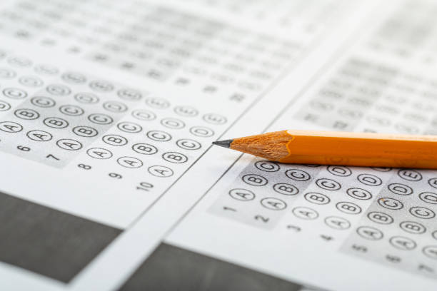 istock testing in exercise and exam paper. computer sheet with pencil in school test room, education concept 1308437050