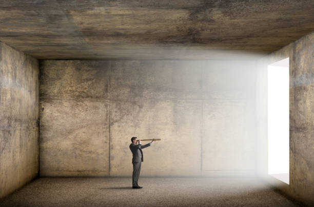 istock Man Looking Out Through A Spyglass 1308437102