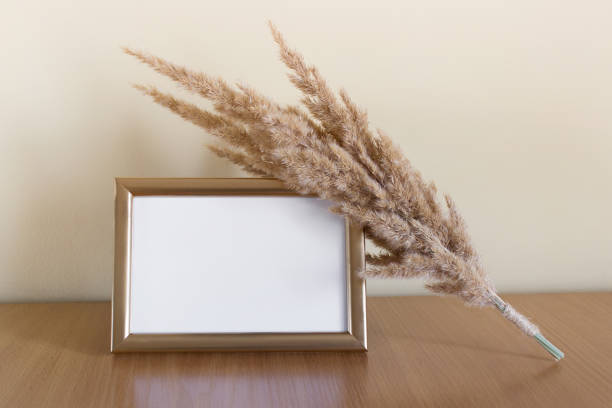 istock Golden photo frame with dry field plants 1308437432