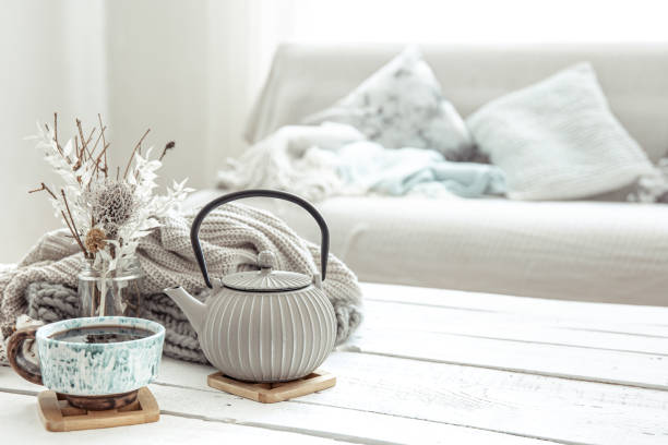 istock Cozy Scandinavian composition with teapot, ceramic cup of tea and decor details copy space. 1308437470