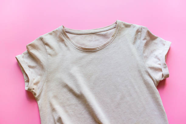 istock Female beige t shirt on pink background 1308438548