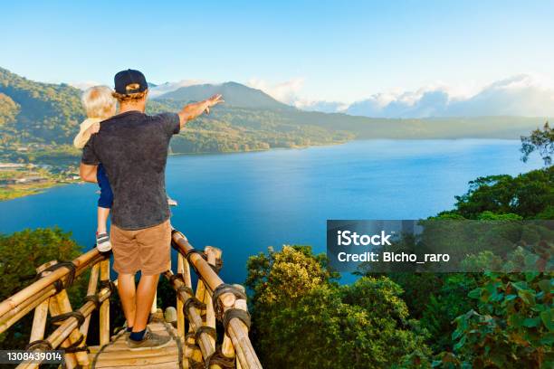 Father With Child Look At Amazing Tropical Lake In Mountains Stock Photo - Download Image Now