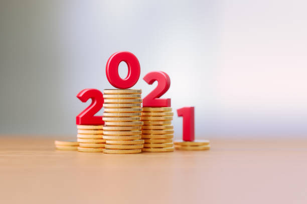 istock Red Letters Sitting On Coin Stacks Write 2021 Before Defocused Background 1308441649