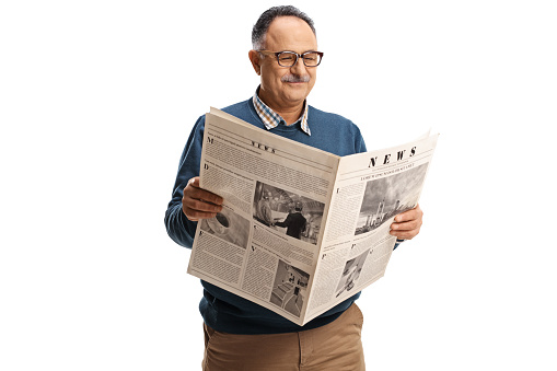 Mature man reading a newspaper and smiling isolated on white background