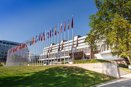 Strasbourg, France, August 2019. Three-quarter view of the Palace of Europe, the building that houses the headquarters of the Council of Europe. In evidence the banidiere of the member states.