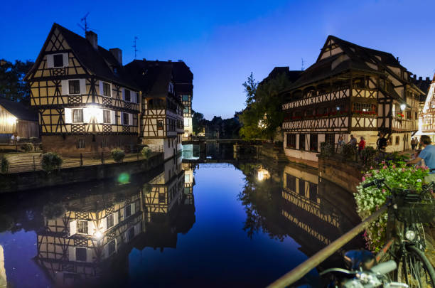 Strasbourg, France. August 2019. Strasbourg, France, August 2019. In the heart of the old town enchanting glimpse of the canals where the typical historic houses are reflected. People stop and look. Large format photos. petite france strasbourg stock pictures, royalty-free photos & images