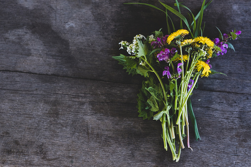 Picture frame wild flowers on grey table