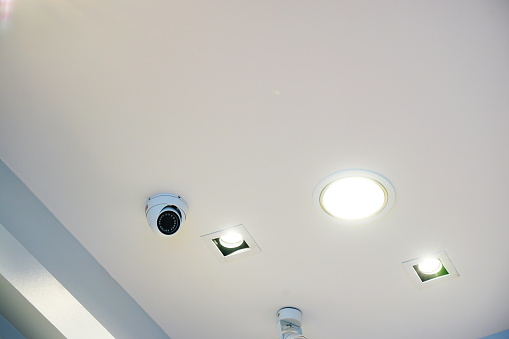 Close-up Modern LED lights and CCTV camera under ceiling