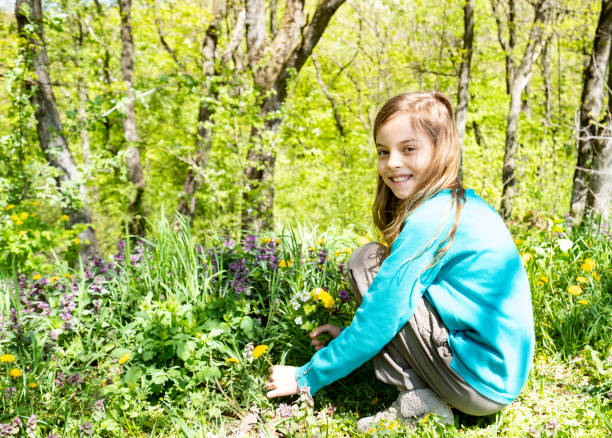 istock Girl picking flowers 1308445420
