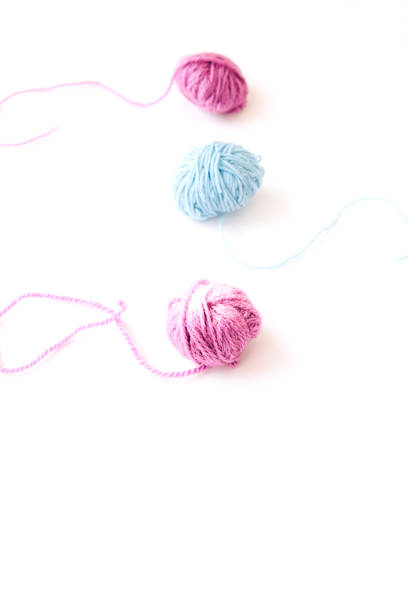 istock Three skeins of multi-colored yarn on light background 1308445569