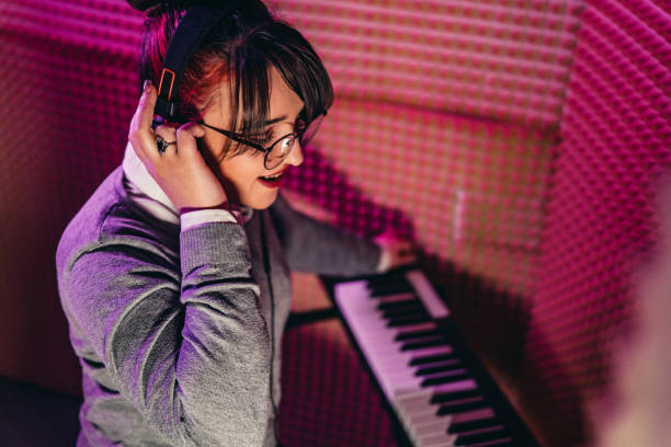 istock Woman playing at a digital piano in studio 1308446314