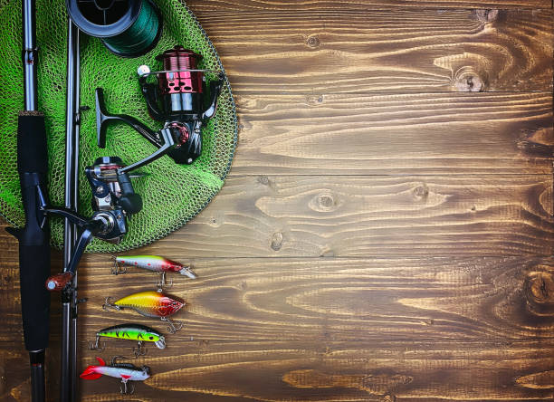istock Fishing tackle. Float, wobbler, bait hooks, on a wooden background. Selective focus 1308446487
