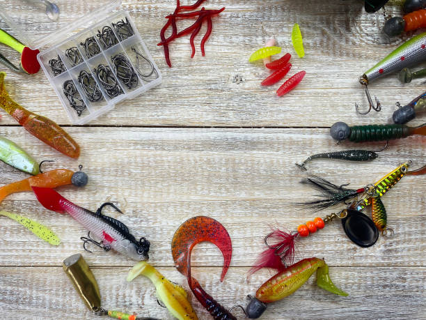istock Fishing tackle. Float, wobbler, bait hooks, on a wooden background. Selective focus 1308446492
