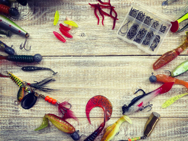 istock Fishing tackle. Float, wobbler, bait hooks, on a wooden background. Selective focus 1308446494