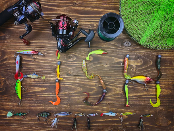 istock Fishing tackle. Float, wobbler, bait hooks, on a wooden background. Selective focus 1308446529