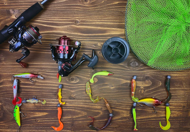 istock Fishing tackle. Float, wobbler, bait hooks, on a wooden background. Selective focus 1308446535