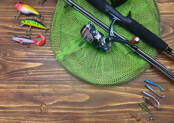 istock Fishing tackle. Float, wobbler, bait hooks, on a wooden background. Selective focus 1308446539