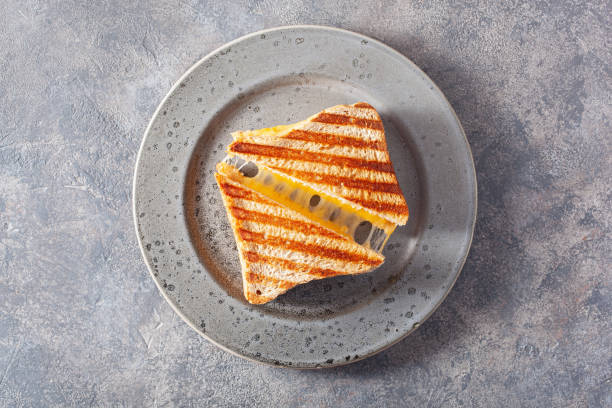 grilled cheese sandwich on gray concrete background - cheese sandwich imagens e fotografias de stock