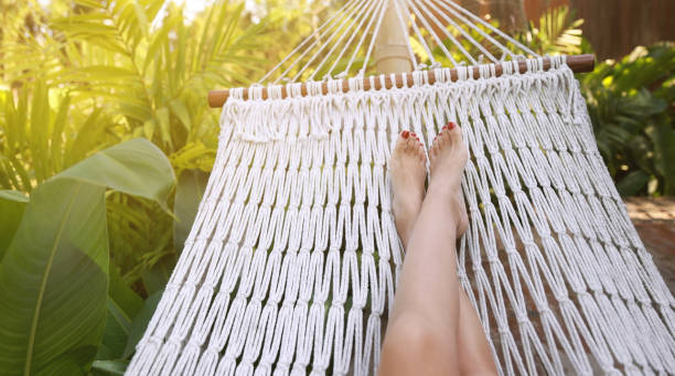 istock Woman swing and relax in hammock 1308448109