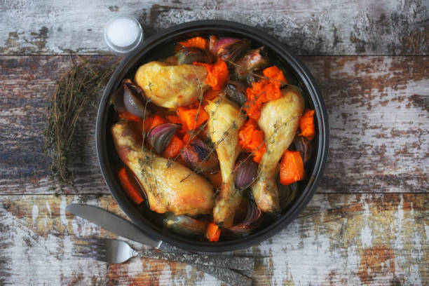 istock Baked chicken legs with pumpkin and blue onions. 1308448222