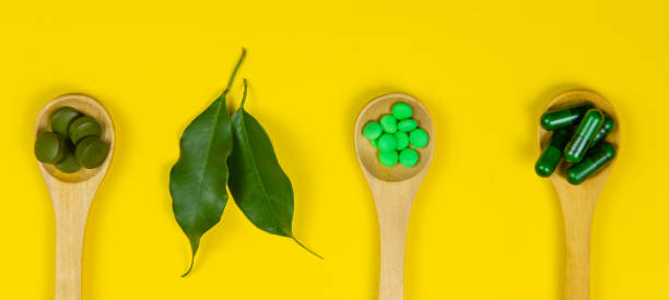 istock Mixed herbal tablets on a wooden spoon. Food supplement. Selective focus 1308448245