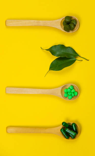 istock Mixed herbal tablets on a wooden spoon. Food supplement. Selective focus 1308448253