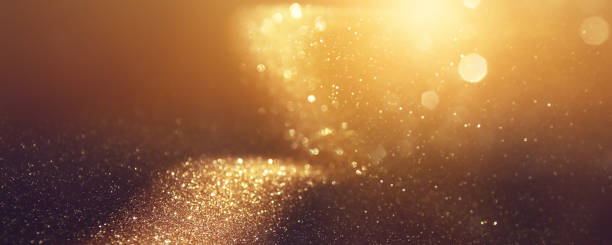 istock background of abstract gold and black glitter lights. defocused 1308448748