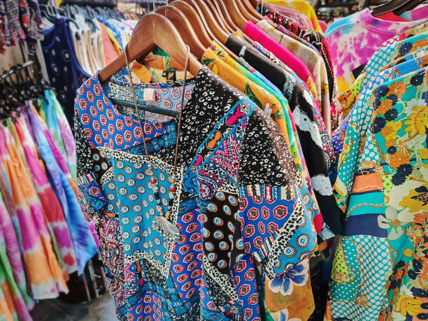 istock Colorful Patterned T Shirts Hanging on the Racks for Sale 1308449786