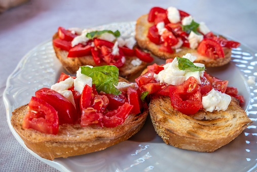 Toasts, bruschetta with cherry tomatoes, mozzarella cheese and fresh basil, Delicious appetizer
