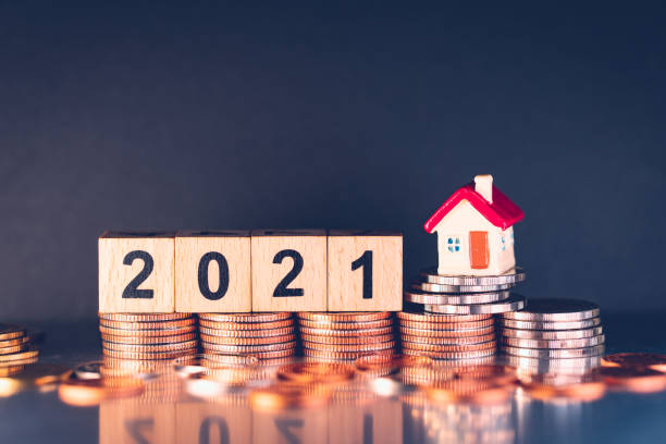 istock Wooden block year 2021 on stack coins 1308451571
